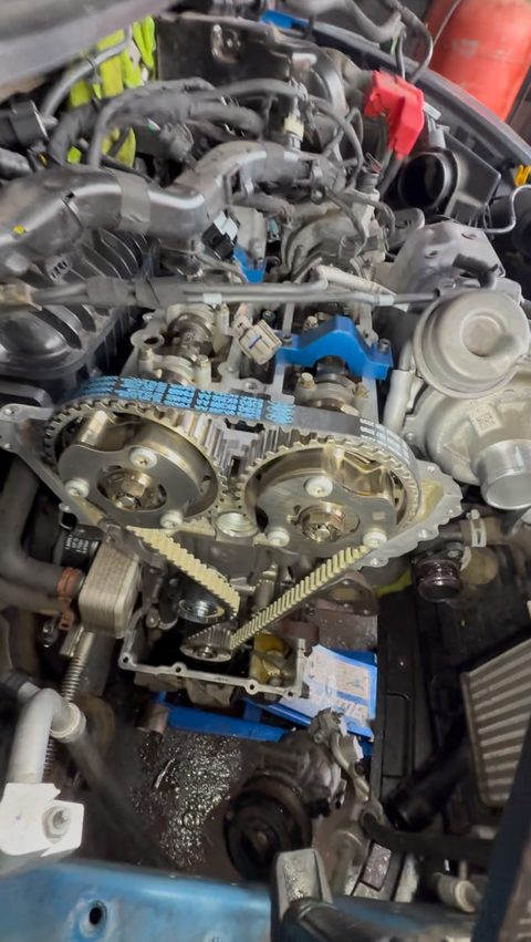 New wet belt fitted on the camshaft pulleys with blue cam locking tools in place, at AGR Performance, Stafford